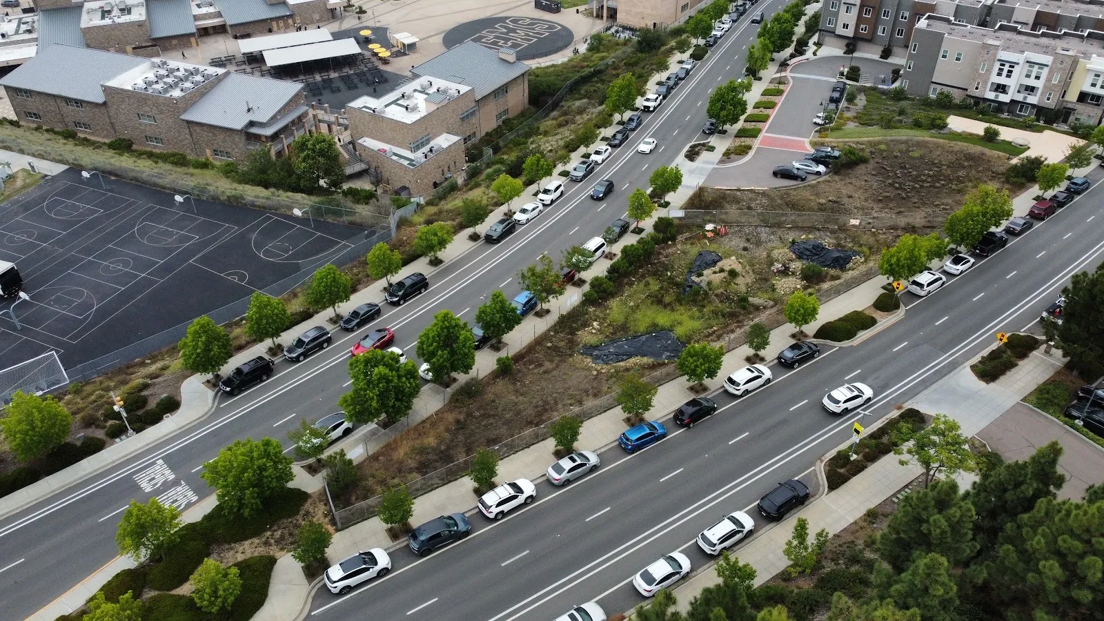 Aerial of the triangle lot, the school, and cars parked along San Elijo Road